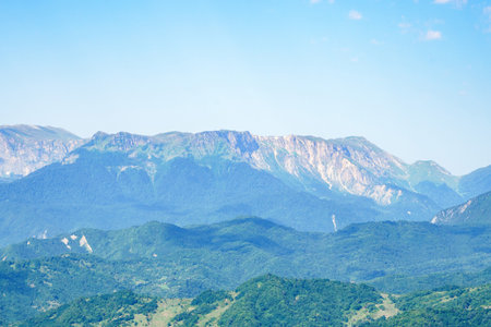 Mountain landscape in Georgia on a clear sunny day. Several green mountain peaksの写真素材