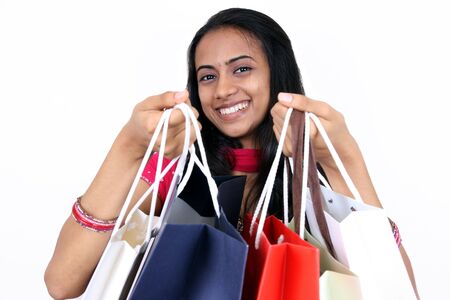 Young girl shopping. Isolated on a white background.の写真素材