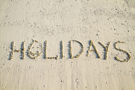 'Holidays' written in white sand.の写真素材
