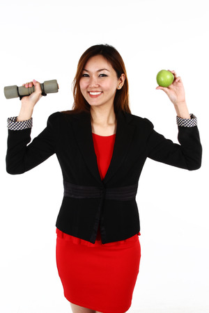 Businesswoman with an apple in her hand - healthy eating conceptの写真素材