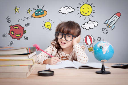 education concept , cute little happy girl at school making homework with creativityの写真素材