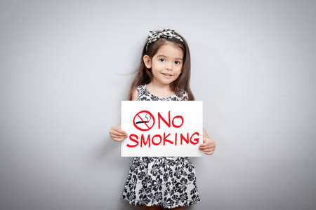 children pretend holding a no smoking signの写真素材