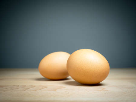 Close up two eggs on wooden tableの写真素材