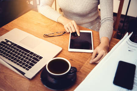 Asian architect woman working at home with tablet and blueprints, engineer inspection in workplace...