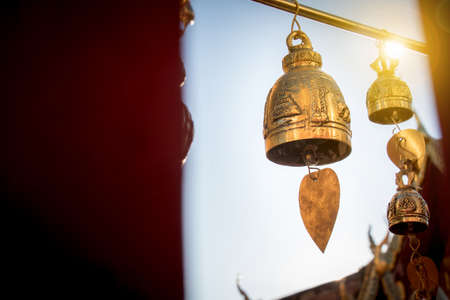 Small bell for pray decorate around Thai buddha temple with sunrise at Doi suthep landmark  for tourist in Chiang Mai province , Thailandの写真素材
