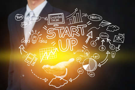 business, startup, presentation, strategy and people concept - business man in suit with startup diagram sketch popup from hand with light effectの写真素材