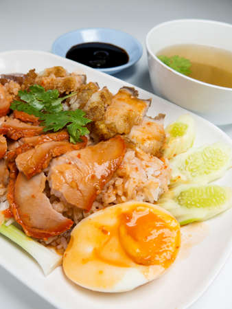 Barbecued red pork and crispy pork in sauce with rice, Chinese style roasted pork. closeupの写真素材