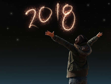Happy Asian girl open arm with joyful on countdown night with firework light for 2018 year. image of...