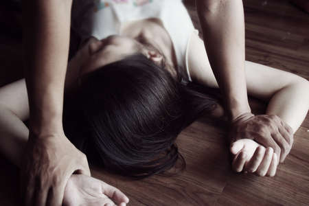 man are using force to coerce and rape woman .stop sexual violence against women campaign.の写真素材