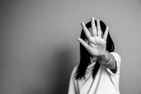 woman raised her hand for dissuade, campaign stop violence against women. Asian woman raised her hand for dissuade with copy space, black and white colorの写真素材