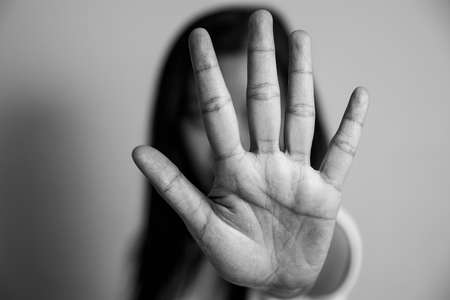 woman raised her hand for dissuade, campaign stop violence against women. Asian woman raised her hand for dissuade with copy space, black and white colorの写真素材