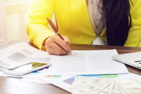 business woman hand signing a contract, close up. contract agreement or business deal conceptの写真素材