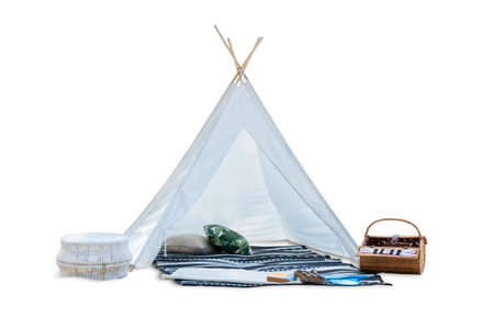 outdoor romantic white picnic tent with picnic food basket , mat and pillow isolated on a white...