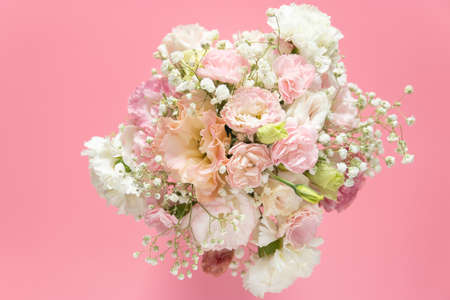 top view of beautiful romantic bouquet fresh flower on pink background with copy spaceの写真素材
