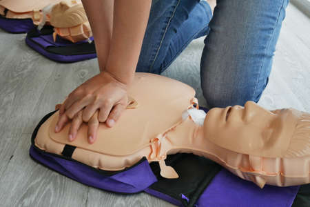 cpr training. close-up of trainee's hand pump on chest of dummy on CPR First Aid Training course for...