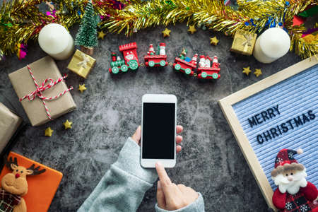 online shopping for Christmas season and gift festival. hand holding mobile phone with blank screen...