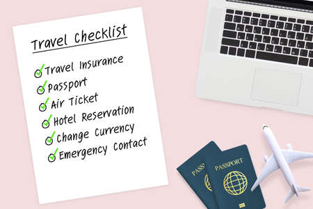 travel checklist paper to prepare before travel with passport , plane model and computer laptop on...