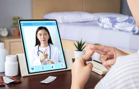 deaf mute patient use video conference, make online consultation by sign language with doctor on tablet application about illness, medicine via vdo call. Telehealth, Telemedicine, online hospitalの写真素材