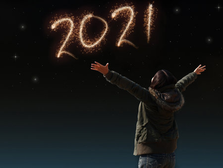 happy Asian girl open arm with joyful on countdown night with firework light for 2021 year. image of happy new year celebration party for seasonal and holiday background wallpaperの写真素材