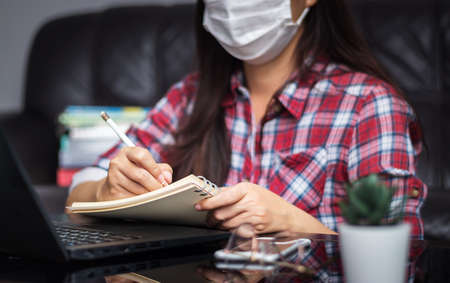 new normal, work from home, study online, homeschooling, distance education. student wear hygienic protect face mask study online listen lecture via laptop at home during  virus    epidemicの写真素材