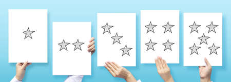 customer experience concept , customer holding paper with satisfied review by star rating feedback for review business serviceの写真素材