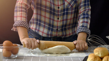 Artisan bread working with dough. Flour dusting on dough, handmade bread dough rolling and kneading...