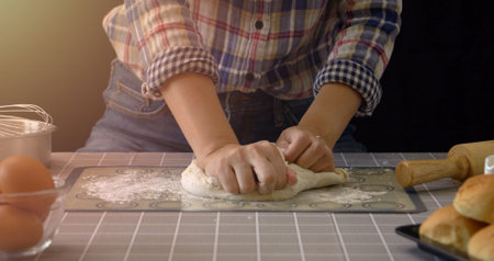 Artisan bread working with dough. Handmade bread kneading in kitchen with bakery equipment tools at...