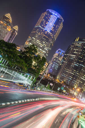Traffic at night in Jakarta, along Indonesia capital city main avenue lined with banks , hotel and luxury shopping malls (Jalan Sudirman) in the business districtのeditorial素材