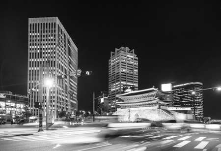 SEOUL, SOUTH KOREA - SEPTEMBER 8 2015: Traffic, captured with long exposure, rushes along the Sungnyemun Gate which is a remain of the old Seoul fortress in the heart of the city.のeditorial素材