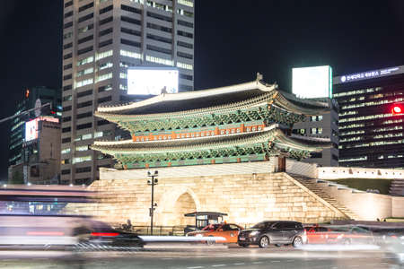 SEOUL, SOUTH KOREA - SEPTEMBER 8 2015: Traffic, captured with long exposure, rushes along the Sungnyemun Gate which is a remain of the old Seoul fortress in the heart of the city.のeditorial素材