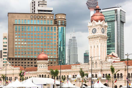 Modern office buildings contrasts with the colonial architecture of the Sultan Abdul Sama building in Kuala Lumpur around Merdeka square in Malaysia capital city.のeditorial素材