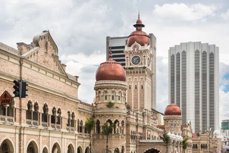 Modern office buildings contrasts with the colonial architecture of the Sultan Abdul Sama building in Kuala Lumpur around Merdeka square in Malaysia capital city.のeditorial素材