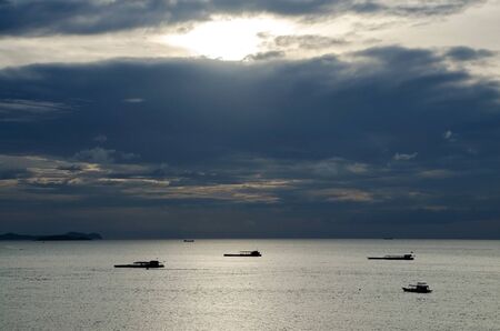 a beautiful view of Pattaya beach during sunset with boats