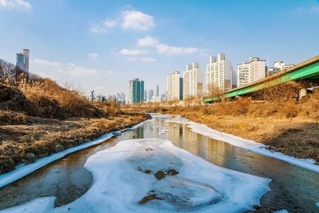 icy river with buildings in Seoulの写真素材