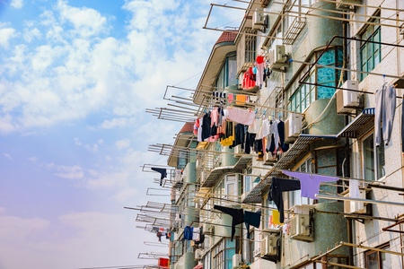 chinese apartments with clothes hanging to dry in Shanghai on a sunny dayの写真素材