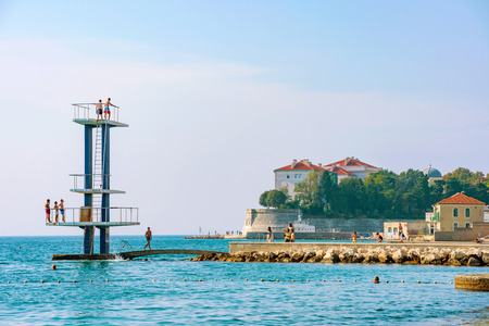 ZADAR, CROATIA - SEPTEMBER 14:  People jumping into the sea from a diving platform on a hot day in the summer on September 14th, 2016 in Zadarのeditorial素材