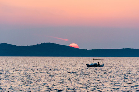 Sunset with boat in Zadarの写真素材