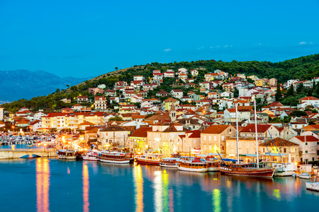 View of buildings on Trogir waterfront at nightの写真素材