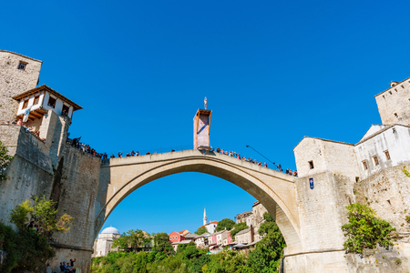 MOSTAR, BOSNIA AND HERZEGOVINA - SEPTEMBER 23: Stari Most bridge and ancient atchitecture with Red Bull diver about to dive on September 23, 2016 in Mostarのeditorial素材