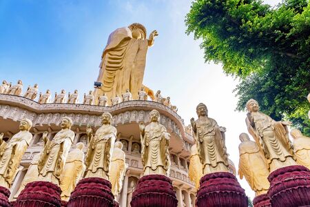Buddha statues with large gold buddha and natureの写真素材