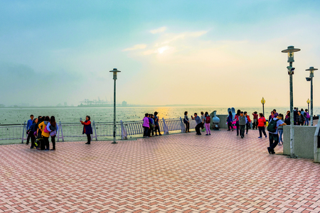 TAIPEI, TAIWAN - JANUARY 05: People on Fisherman's wharf pier during sunset in the tamsui area of Taipei on January 05, 2017 in Taipeiのeditorial素材