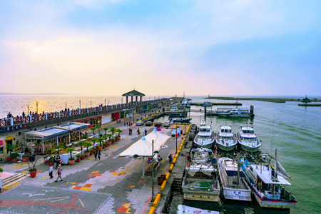 TAIPEI, TAIWAN - JANUARY 05: View of Fisherman's wharf waterfront area with boats in Tamsui a...