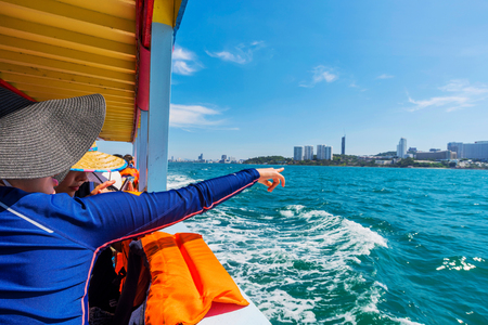PATTAYA, THAILAND - JANUARY 19: This is a traveller pointing to Pattaya city from a boat on its way to another island nearby on January 19, 2017 in Pattayaのeditorial素材