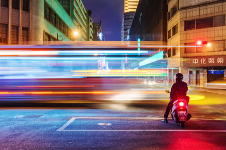 TAIPEI, TAIWAN - MAY 27: This is a night view of motorcyclist waiting at traffic lights for the light to change to green in the downtown area on May 27, 2017 in Taipeiのeditorial素材