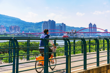 TAIPEI, TAIWAN - MAY 29: This is scenic view of a man cycling on a riverside path onn the outskirts of Taipei on a hot sunny day on May 29, 2017 in Taipeiのeditorial素材