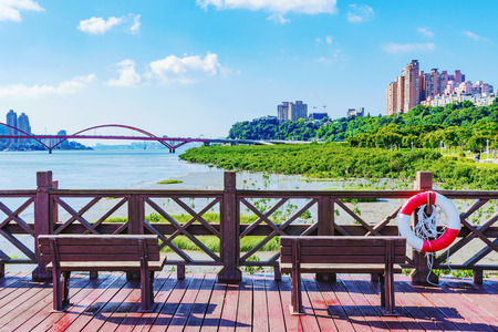 Pier with benches overlooking the riverside area in Taipeiの写真素材