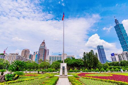 TAIPEI, TAIWAN - MAY 31: Taiwan flag raised in Sun Yat-sen memorial hall with Xinyi financial district architecture in the background on May 31, 2017 in Taipeiのeditorial素材