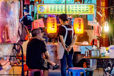TAIPEI, TAIWAN - JUNE 19: This is a night scene of a street vendor in the Raohe street night market....
