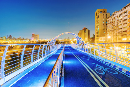 Bridge over Guting riverside park in Taipei at nightの写真素材
