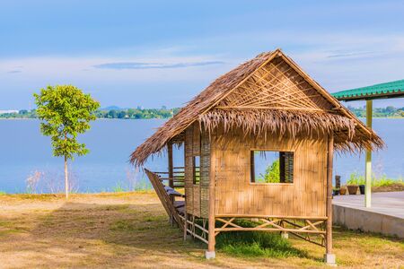 Lake view with a traditional hut in Thailandの写真素材